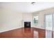Cozy living room featuring hardwood floors, a corner fireplace, and sliding glass doors to the outside at 931 Society Cir, Atlanta, GA 30331