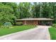 Inviting home with a long driveway, lush green lawn, and a covered porch perfect for relaxing outdoors at 1630 Park Ln, Marietta, GA 30066