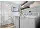 Bright laundry room with white appliances and ample shelving at 1630 Park Ln, Marietta, GA 30066