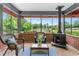 Screened-in porch with a rustic fireplace, comfortable seating, and scenic views, perfect for all seasons at 1630 Park Ln, Marietta, GA 30066