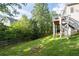 Lush backyard featuring a well-maintained lawn, wooden fence, and stairs to a deck at 1745 Habersham Marina Rd, Cumming, GA 30041