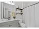 Bathroom features sleek vanity, updated fixtures, shower with curtain, and modern tile flooring at 1745 Habersham Marina Rd, Cumming, GA 30041