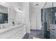 Bathroom with double granite vanity, walk-in shower and blue tile at 1745 Habersham Marina Rd, Cumming, GA 30041