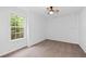 Bright bedroom featuring a large window and a ceiling fan at 1745 Habersham Marina Rd, Cumming, GA 30041