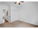 Carpeted bedroom with fan, closet, and an entryway leading to another room at 1745 Habersham Marina Rd, Cumming, GA 30041