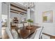 Dining area overlooking the living room features a modern chandelier and seating for six at 1745 Habersham Marina Rd, Cumming, GA 30041