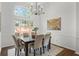 Dining area with a modern chandelier, large window, and seating for six at 1745 Habersham Marina Rd, Cumming, GA 30041