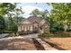 Beautiful exterior view of the home, showcasing its well-maintained yard and mature trees at 1745 Habersham Marina Rd, Cumming, GA 30041