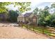 Beautiful exterior view of the home, showcasing its well-maintained yard and mature trees at 1745 Habersham Marina Rd, Cumming, GA 30041