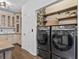Kitchen with custom shelves, black stainless steel washer and dryer, and access door at 1745 Habersham Marina Rd, Cumming, GA 30041