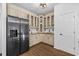Bright kitchen features stainless steel refrigerator, granite countertops, and custom cabinetry at 1745 Habersham Marina Rd, Cumming, GA 30041