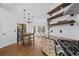 Eat-in kitchen showcasing open shelving, stainless steel appliances, and wood flooring at 1745 Habersham Marina Rd, Cumming, GA 30041
