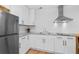 Modern kitchen featuring white cabinets, stainless steel appliances, and light countertops at 1745 Habersham Marina Rd, Cumming, GA 30041