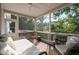 Inviting screened porch with ceiling fan and comfortable seating, perfect for relaxing and enjoying the outdoors at 1745 Habersham Marina Rd, Cumming, GA 30041