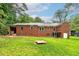 Brick home's rear exterior with backyard access and a glimpse of outdoor living spaces at 3080 Lynhurst Cir, Atlanta, GA 30311