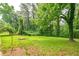 Lush, expansive backyard with mature trees offers plenty of space for outdoor activities at 3080 Lynhurst Cir, Atlanta, GA 30311