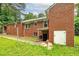 Brick home with grassy yard, rear entrance, and mature trees, a serene retreat at 3080 Lynhurst Cir, Atlanta, GA 30311
