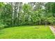 Large, grassy backyard shaded by tall trees, perfect for recreation and relaxation at 3080 Lynhurst Cir, Atlanta, GA 30311