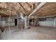 Unfinished basement shows exposed beams and pipes, concrete floor and stairway at 3080 Lynhurst Cir, Atlanta, GA 30311
