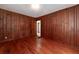 Cozy wood-paneled bedroom with a door leading to another room at 3080 Lynhurst Cir, Atlanta, GA 30311
