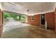 Spacious covered carport offering protection with brick column supports and access to the home's entry at 3080 Lynhurst Cir, Atlanta, GA 30311