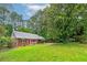 Traditional brick home boasts a lush green lawn, mature trees, and charming curb appeal at 3080 Lynhurst Cir, Atlanta, GA 30311
