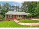 Inviting front exterior of a brick home, enhanced by lush landscaping and a covered carport at 3080 Lynhurst Cir, Atlanta, GA 30311