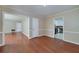 Open living room showcasing hardwood floors and neutral paint, flowing into the kitchen at 3080 Lynhurst Cir, Atlanta, GA 30311