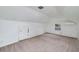 View of the carpeted room showing a window, white walls, and door to storage at 3080 Lynhurst Cir, Atlanta, GA 30311