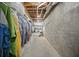 Long, narrow basement storage area with concrete walls and ceiling pipes at 4525 Cavallon Nw Way, Acworth, GA 30101