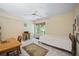 Cozy bedroom with neutral tones, a ceiling fan, a window, a wood desk, and a plush rug at 4525 Cavallon Nw Way, Acworth, GA 30101