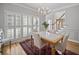 Dining room with wood floors, chandelier, and large windows with shutter blinds at 4525 Cavallon Nw Way, Acworth, GA 30101