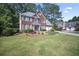 Inviting two-story home featuring a brick facade, well-maintained lawn, and two-car garage at 4525 Cavallon Nw Way, Acworth, GA 30101