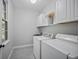 Bright laundry room with white cabinetry, a sink, and included washer and dryer at 4525 Cavallon Nw Way, Acworth, GA 30101