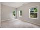 Well-lit bedroom with three windows showcasing neighborhood views and landscaped backyard at 1463 Edgebrook Ne Ct # 14, Atlanta, GA 30329