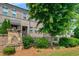 Charming exterior of a townhouse with a stone pillar and mature landscaping in a well manicured yard at 1463 Edgebrook Ne Ct # 14, Atlanta, GA 30329