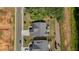 Aerial view of a home with a well-maintained yard featuring an outdoor stone fireplace and patio area at 203 Belmont Park Dr, Canton, GA 30115