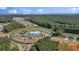 A scenic aerial view of new homes in a planned community nestled among trees and modern amenities at 203 Belmont Park Dr, Canton, GA 30115