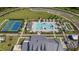 An aerial view highlighting the tennis courts, swimming pool, cabanas, and landscaping at the community center at 203 Belmont Park Dr, Canton, GA 30115