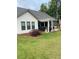 Beautiful backyard with a stone patio, black grill, green grass and wooden fence at 203 Belmont Park Dr, Canton, GA 30115