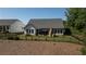 Home exterior with a fenced yard featuring a covered patio and an outdoor stone fireplace for entertaining at 203 Belmont Park Dr, Canton, GA 30115
