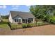 Beautifully fenced backyard features a covered patio with a stone fireplace and ample green space at 203 Belmont Park Dr, Canton, GA 30115