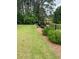 Green backyard featuring a black metal fence and garden at 203 Belmont Park Dr, Canton, GA 30115