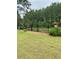 Landscaped backyard with a black metal fence and garden at 203 Belmont Park Dr, Canton, GA 30115