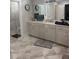 Elegant bathroom with a long vanity, granite countertops, and a soaking tub at 203 Belmont Park Dr, Canton, GA 30115