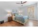 Cozy bedroom with hardwood floors, ceiling fan, and neutral decor at 203 Belmont Park Dr, Canton, GA 30115