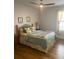 Cozy bedroom with hardwood floors, a decorative headboard, and a window with patterned curtains at 203 Belmont Park Dr, Canton, GA 30115