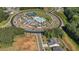 Aerial view of the community pool and clubhouse surrounded by lush greenery and well-maintained grounds at 203 Belmont Park Dr, Canton, GA 30115
