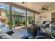 Inviting covered patio featuring a stone fireplace, comfortable seating, and an outdoor dining area perfect for entertaining at 203 Belmont Park Dr, Canton, GA 30115