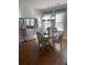 Charming dining room with hardwood floors, elegant chandelier, and window views at 203 Belmont Park Dr, Canton, GA 30115